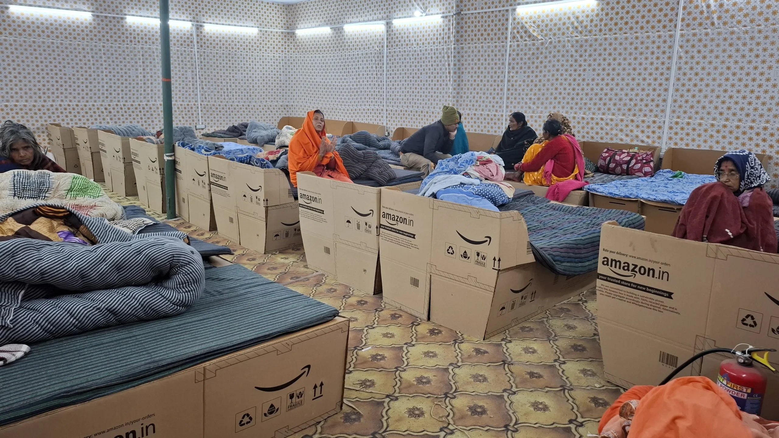 Amazon India, Maha Kumbh Mela 2025, upcycled beds, cardboard box beds, sustainable innovation, social impact, Prayagraj, festival accommodation, Amazon packaging, Ogilvy India, Kumbh Mela initiative, community support, lost and found center, Kumbh Police, Kumbh hospital, pilgrimage support, corporate social responsibility, eco-friendly initiative, public welfare, festival comfort, innovative solutions, repurposed materials, Amazon corporate initiatives, sustainable festival solutions, large-scale religious gatherings, Maha Kumbh social initiatives, Amazon India community projects, smart packaging reuse, festival infrastructure, environmental responsibility, green initiatives, Maha Kumbh public service, social responsibility in business, 